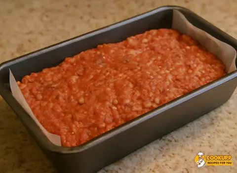 Shaped meatloaf mixture placed in a loaf pan