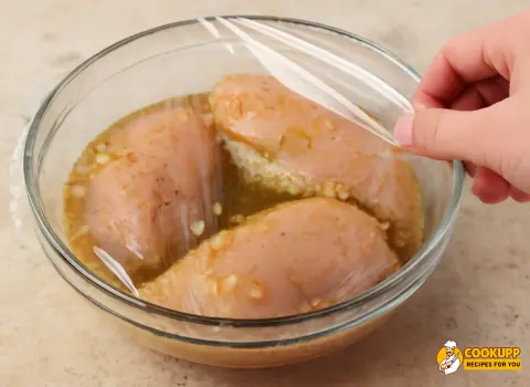 Marinated chicken breasts in a bowl for Cava Grilled Chicken